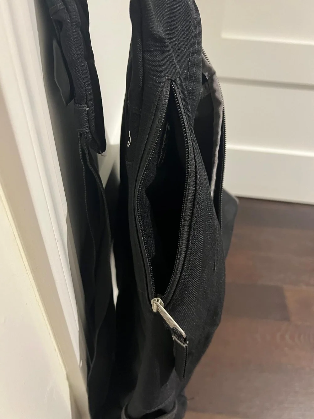 Jansport Black Sling Backpack with Front Zip Pocket